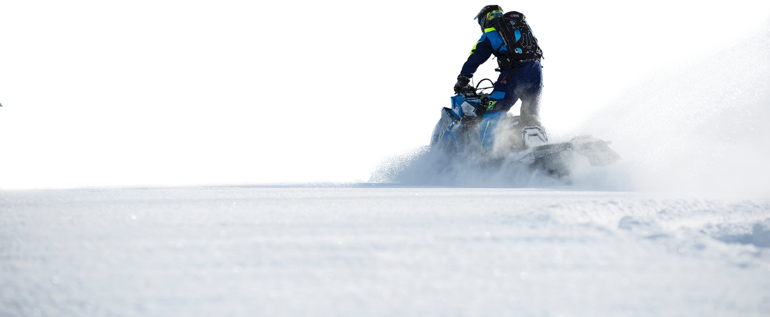 Snowmobile rider plowing through fresh powder